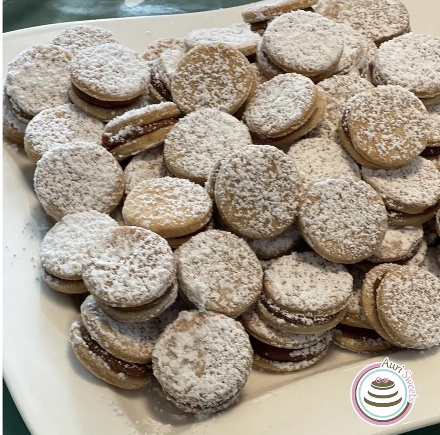 A platter of alfajores dusted with powdered sugar