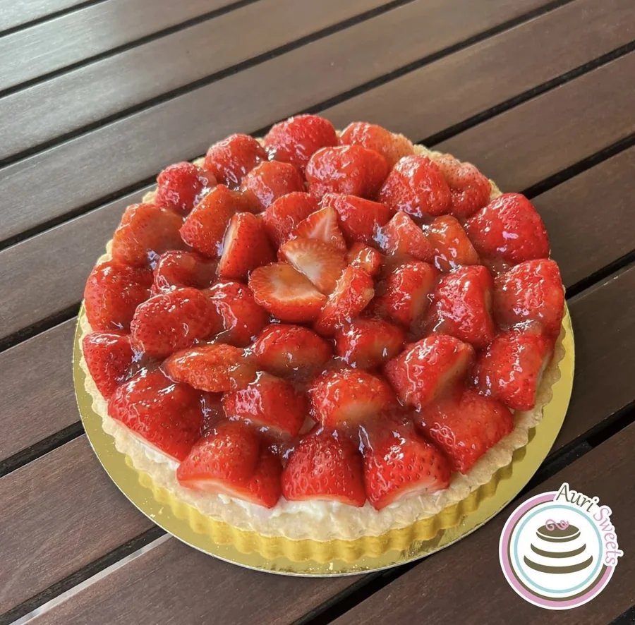 Round strawberry tart with glossy sliced strawberries
